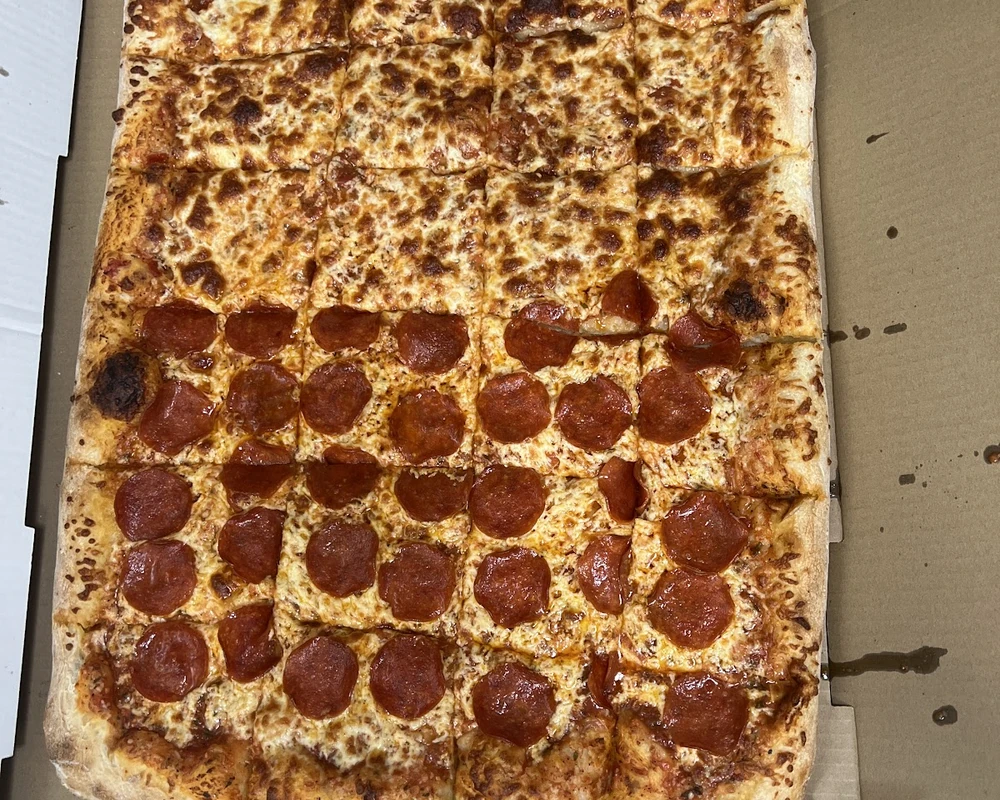 Fresh pizza, chicken wings and arancini at Ancaster Pizza in Ancaster, Ontario